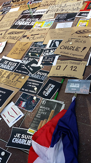 Posters and placards at the Charlie Hebdo rally today. Reporters Without Borders placard and French flag are on the bottom right corner. Image: David Robie/PMC