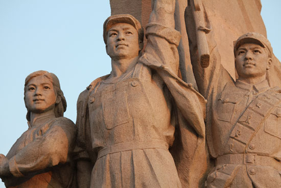 The setting sun casts a golden hue on the Statue to the People in Beijing's Tiananmen Square on the 90th birthday of the Communist Party of China.  Photo: Kim Bowden / PMC