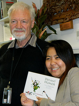 Pacific Media Centre director Professor David Robie with Kyaw Hsu Mon, who is holding a book by political cartoonist Harn Lay of The Irrawaddy. Image: Del Abcede/PMC