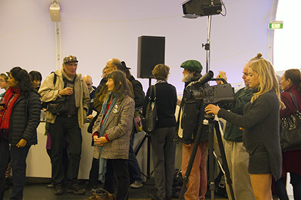 Fiji journalist Shobna Chandra (from left), NZ photojournalist John Miller (in Chinese cap) and AUT student journalist Senka Bosnyak (with TV camera) at the book launch. Image: Del Abcede/PMC