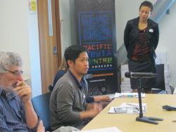 PhD candidate Alwin Aguirre speaking with Dr Camille Nakhid (standing). Image: Anna Majavu/PMC