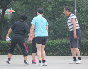 A game of jianzi, a Chinese hacky sack game using a shuttlecock, is played in a neighbourhood park in northeast Beijing. Photo: Kim Bowden/PMC