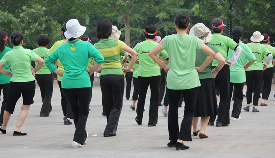 Women learn a group dance in a neighbourhood park in northeast Beijing. Photo: Kim Bowden/PMC