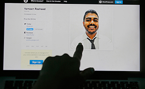 A Sri Lankan woman in Colombo points to a photo of murdered Maldivian blogger Yameen Rasheed from his blog. Image: Eranga Jayawardena/CPJ