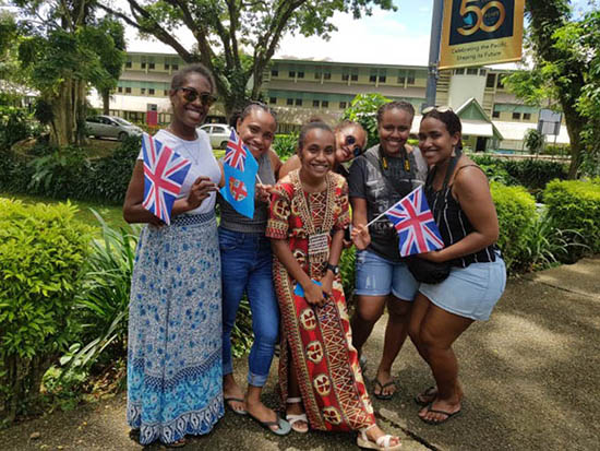 Solomon Islands student Cynthia Hou (middle) is flanked by friends at USP’s Laucala campus. Image: Mereoni Mili/Wansolwara