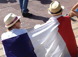 Freedom of speech supporters draped in the French national flag today. Image: TV3