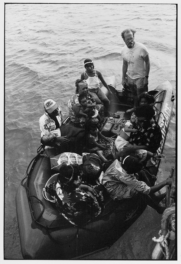 Steve Sawyer assisting Rongelap islanders to leave the radiated atoll on board the Rainbow Warrior in May 1985. Image: © David Robie/Eyes of Fire
