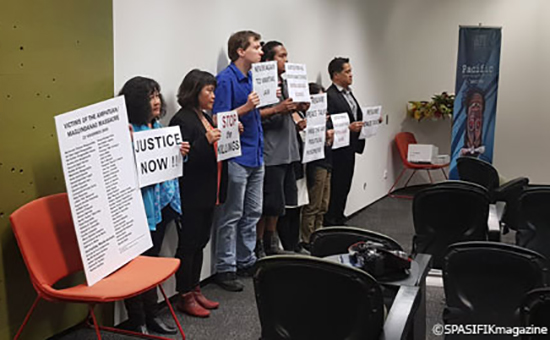 Protesters hold placards condemning the extrajudicial killings and the lack of justice over the 2009 Ampatuan massacre in the Philippines. Image: Mata Lauano/Spasifik