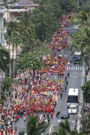 Thousands of people walk down Kalakaua Avenue, Honolulu during Sunday’s Aloha Aina Unity March. Image: Cory Lum/ HCB