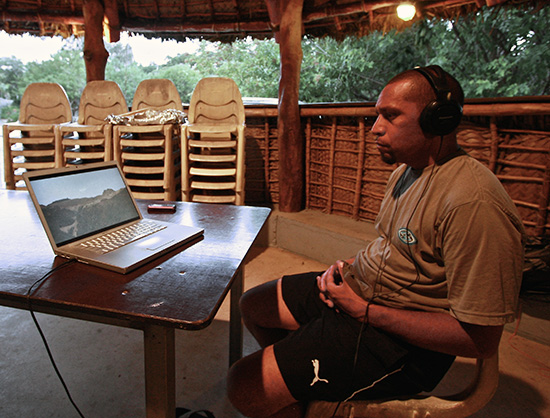 Yamel Euritein, an Aije language consultant, takes a break from the Yam festival to watch the Cap Bocage documentary. Image: Jim Marbrook/PMC